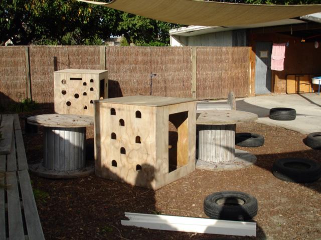 Outdoor activity space with wooden play boxes and tables