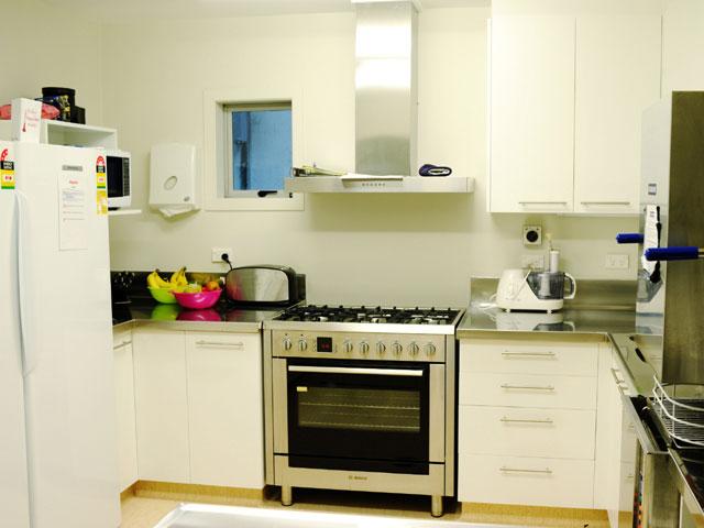 Modern kitchen with large fridge and dishwasher