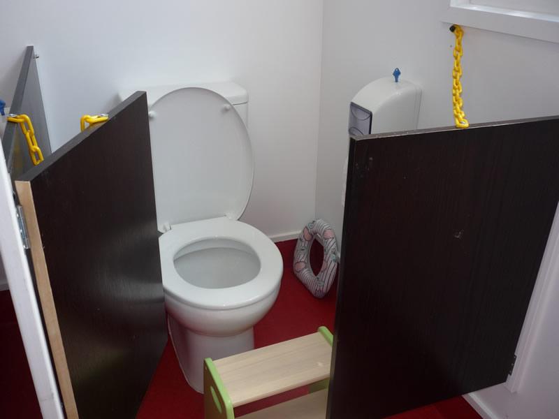 Private toilet with wide swing doors for a large space