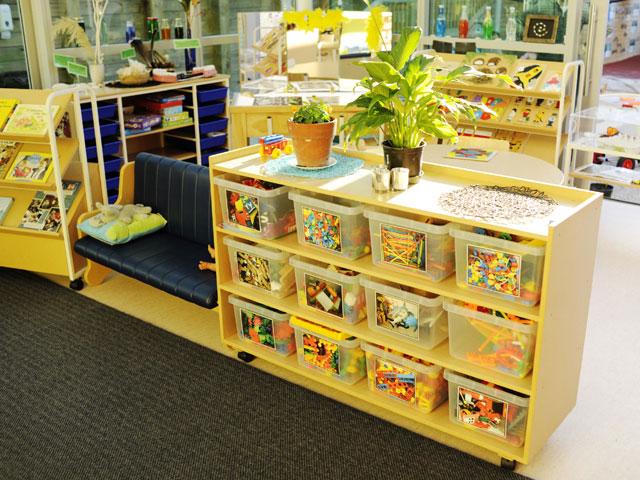 Large plastic drawers in large wooden storage unit